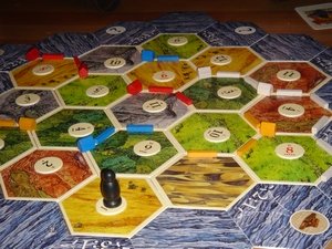 Click to read our Settlers of Catan review!